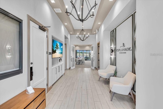 10410 Inglenook Ter, Palmetto, FL 34221 - hallway with a chandelier, light wood-type flooring, recessed lighting, and a raised ceiling