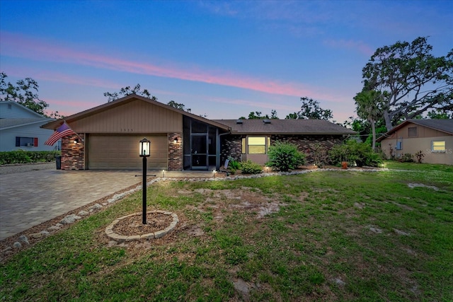 1515 Pecan St, Nokomis, FL 34275 - mid-century inspired home with a garage, decorative driveway, brick siding, a sunroom, and a front yard