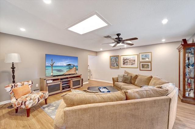 1515 Pecan St, Nokomis, FL 34275 - living room featuring baseboards, recessed lighting, a skylight, ceiling fan, and light wood-style flooring