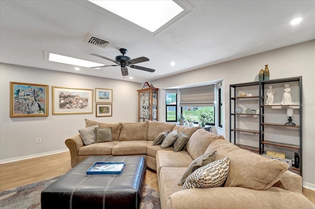 1515 Pecan St, Nokomis, FL 34275 - living room featuring a skylight, ceiling fan, wood finished floors, recessed lighting, and baseboards