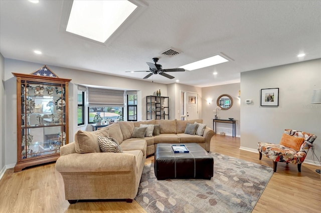 1515 Pecan St, Nokomis, FL 34275 - living room with a skylight, light wood-style floors, baseboards, ceiling fan, and recessed lighting