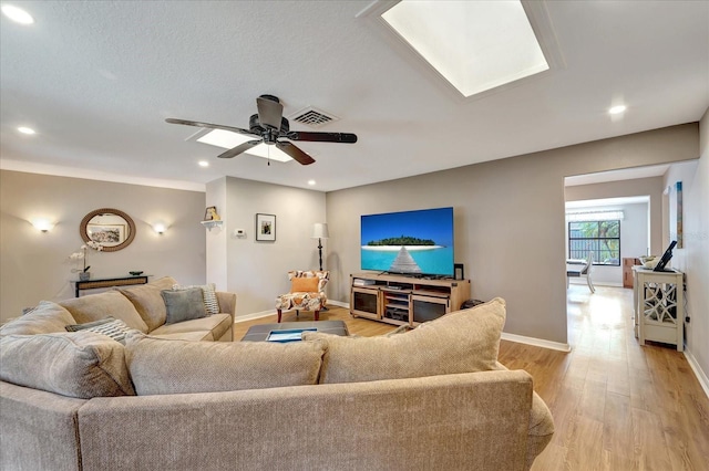 1515 Pecan St, Nokomis, FL 34275 - living room with light wood finished floors, baseboards, recessed lighting, ceiling fan, and a skylight