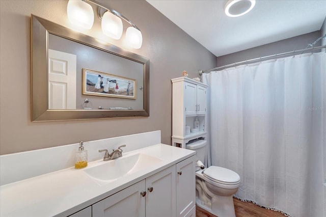 1515 Pecan St, Nokomis, FL 34275 - bathroom featuring toilet, vanity, wood finished floors, and a shower with curtain
