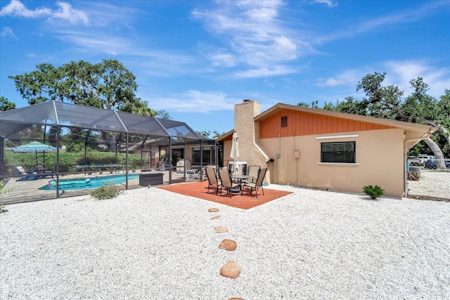 1515 Pecan St, Nokomis, FL 34275 - back of house featuring a patio, an outdoor pool, a chimney, and glass enclosure