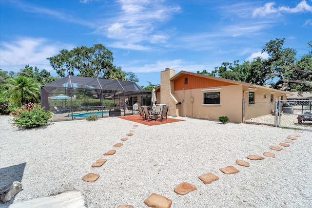 1515 Pecan St, Nokomis, FL 34275 - back of property featuring an outdoor pool, a gate, stucco siding, a patio, and a chimney