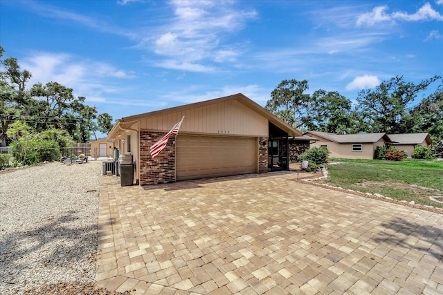 1515 Pecan St, Nokomis, FL 34275 - view of front of home featuring an attached garage, decorative driveway, and brick siding