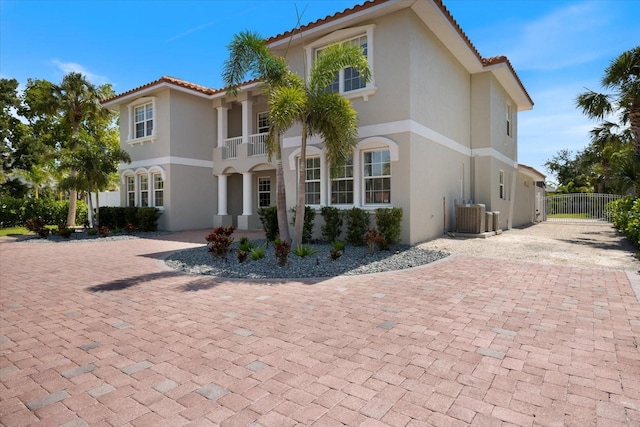 2322 Bayshore Rd, Nokomis, FL 34275 - mediterranean / spanish home featuring stucco siding, decorative driveway, a balcony, and a tiled roof