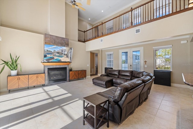 2322 Bayshore Rd, Nokomis, FL 34275 - living area with light tile patterned flooring, ceiling fan, baseboards, a high ceiling, and ornamental molding
