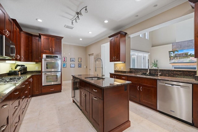 2322 Bayshore Rd, Nokomis, FL 34275 - kitchen featuring stainless steel appliances, a sink, ornamental molding, dark stone countertops, and a kitchen island with sink