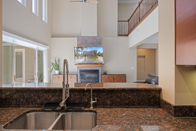 2322 Bayshore Rd, Nokomis, FL 34275 - kitchen with a sink, a high ceiling, dark stone counters, and a ceiling fan