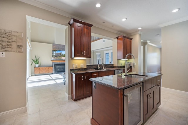2322 Bayshore Rd, Nokomis, FL 34275 - kitchen with wine cooler, a sink, an island with sink, dark stone counters, and ornamental molding