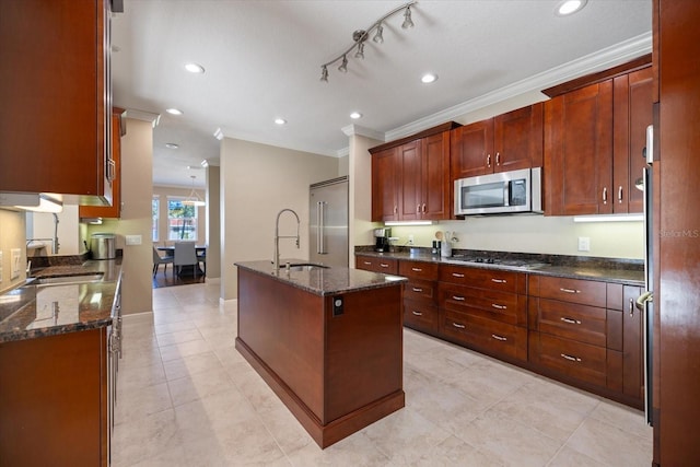 2322 Bayshore Rd, Nokomis, FL 34275 - kitchen with appliances with stainless steel finishes, a sink, ornamental molding, a kitchen island with sink, and dark stone countertops