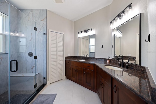 2322 Bayshore Rd, Nokomis, FL 34275 - bathroom featuring double vanity, a shower stall, a closet, and tile patterned flooring