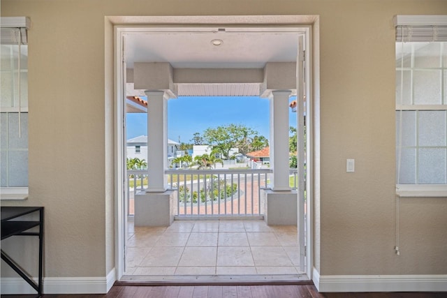 2322 Bayshore Rd, Nokomis, FL 34275 - doorway to outside with decorative columns, wood finished floors, and healthy amount of natural light