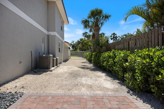 2322 Bayshore Rd, Nokomis, FL 34275 - view of side of property featuring stucco siding and central air condition unit