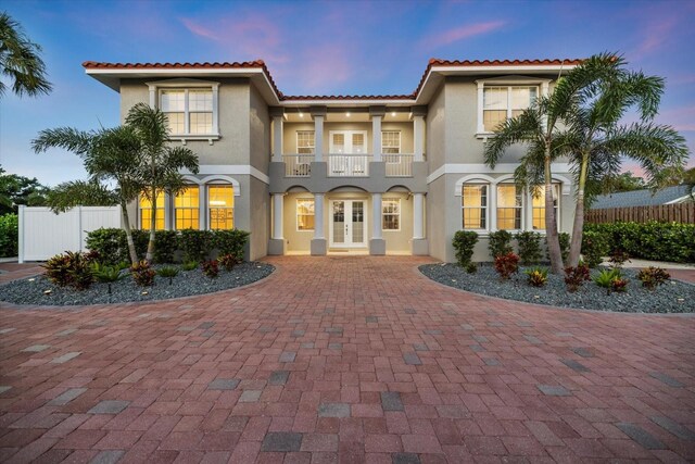 2322 Bayshore Rd, Nokomis, FL 34275 - mediterranean / spanish home with french doors, a balcony, stucco siding, curved driveway, and a tile roof