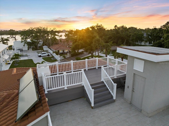 2322 Bayshore Rd, Nokomis, FL 34275 - patio terrace at dusk with a patio area, a deck, and stairs