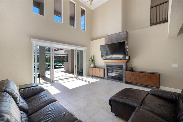 2322 Bayshore Rd, Nokomis, FL 34275 - living room with a high ceiling, light tile patterned floors, and a ceiling fan