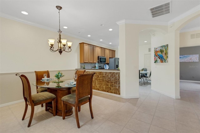 2104 Batello Dr, Venice, FL 34292 - dining room with crown molding, recessed lighting, arched walkways, a chandelier, and baseboards