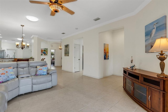 2104 Batello Dr, Venice, FL 34292 - living room with a chandelier, a ceiling fan, crown molding, light tile patterned floors, and baseboards