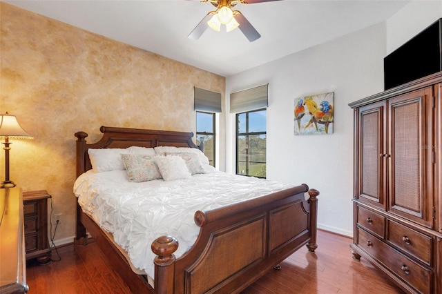 2104 Batello Dr, Venice, FL 34292 - bedroom featuring wood finished floors, baseboards, and ceiling fan