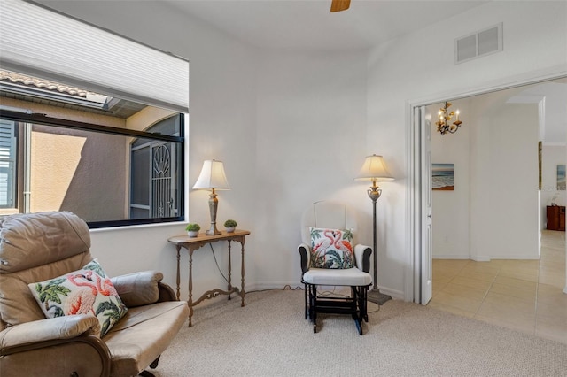 2104 Batello Dr, Venice, FL 34292 - living area featuring a chandelier, carpet flooring, tile patterned floors, a ceiling fan, and baseboards