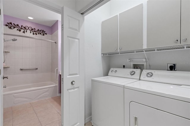 2104 Batello Dr, Venice, FL 34292 - laundry area featuring cabinet space, washing machine and clothes dryer, and light tile patterned floors