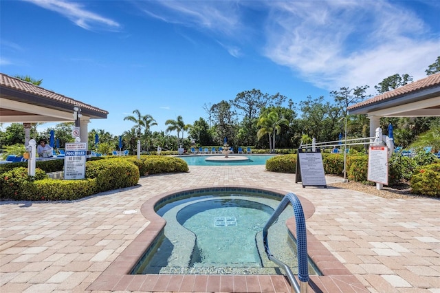 2104 Batello Dr, Venice, FL 34292 - community pool featuring a hot tub and a patio area