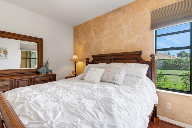 2104 Batello Dr, Venice, FL 34292 - bedroom with baseboards and wood finished floors