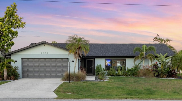 5140 Administration St, Port Charlotte, FL 33948 - single story home with an attached garage, concrete driveway, a front yard, stucco siding, and roof with shingles