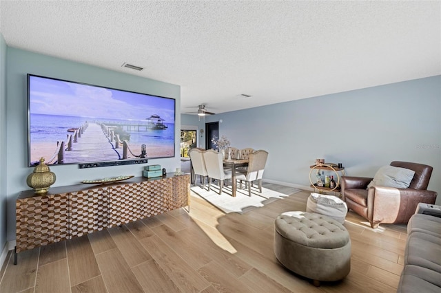 5140 Administration St, Port Charlotte, FL 33948 - living room featuring a textured ceiling, wood finished floors, and ceiling fan