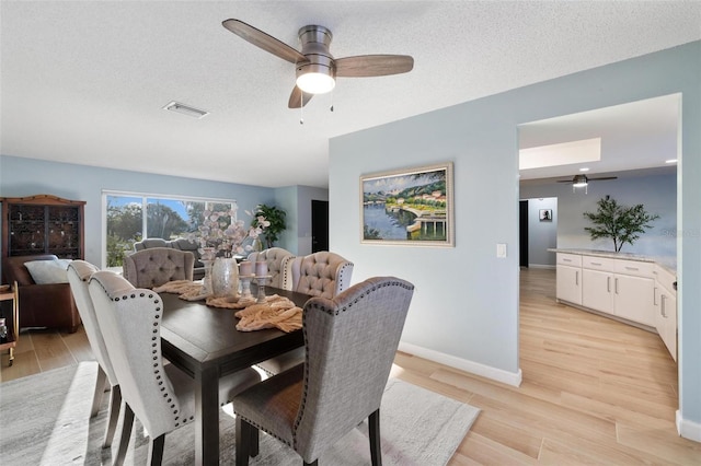 5140 Administration St, Port Charlotte, FL 33948 - dining area featuring ceiling fan, light wood finished floors, baseboards, and a textured ceiling