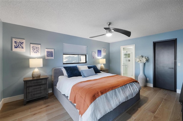 5140 Administration St, Port Charlotte, FL 33948 - bedroom featuring wood finish floors, a textured ceiling, baseboards, ceiling fan, and ensuite bathroom