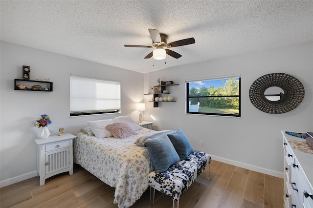 5140 Administration St, Port Charlotte, FL 33948 - bedroom with multiple windows, light wood-style flooring, baseboards, and a textured ceiling