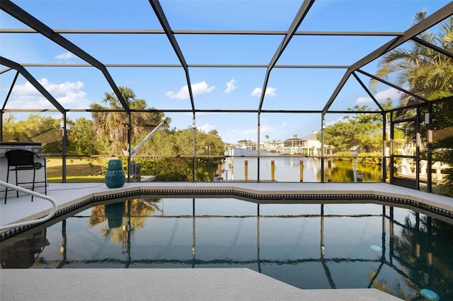 5140 Administration St, Port Charlotte, FL 33948 - swimming pool featuring glass enclosure, a water view, and a patio