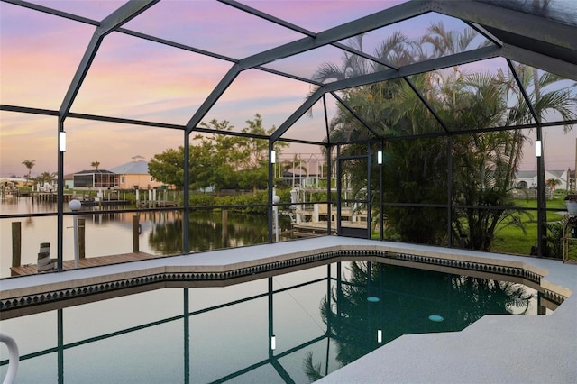 5140 Administration St, Port Charlotte, FL 33948 - pool at dusk featuring a water view, an outdoor pool, and a lanai