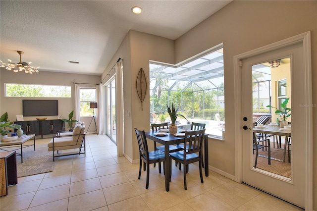 8209 Snowy Egret Pl, Bradenton, FL 34202 - dining space featuring light tile patterned floors, baseboards, a sunroom, and a textured ceiling