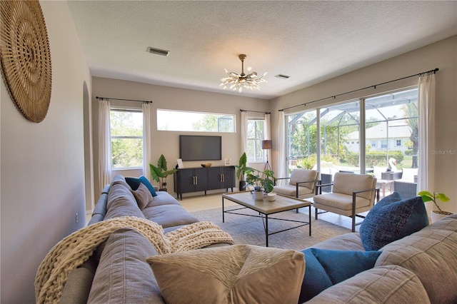 8209 Snowy Egret Pl, Bradenton, FL 34202 - living area featuring a chandelier and a textured ceiling