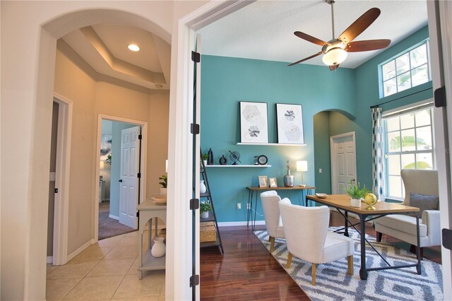 8209 Snowy Egret Pl, Bradenton, FL 34202 - office area with arched walkways, a ceiling fan, a towering ceiling, and baseboards
