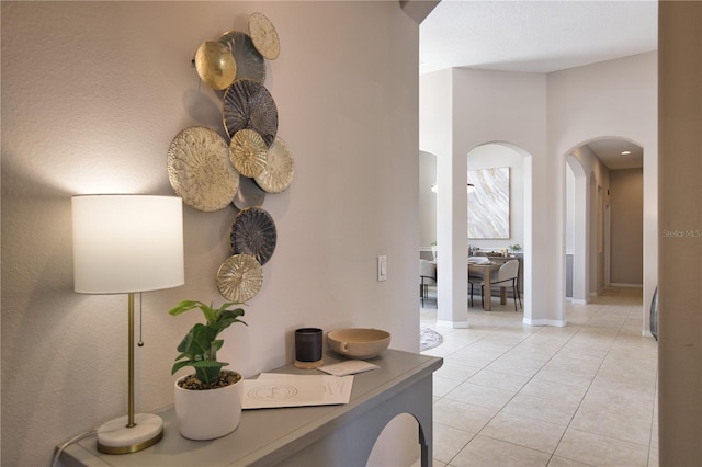 8209 Snowy Egret Pl, Bradenton, FL 34202 - hall featuring arched walkways, light tile patterned floors, and baseboards