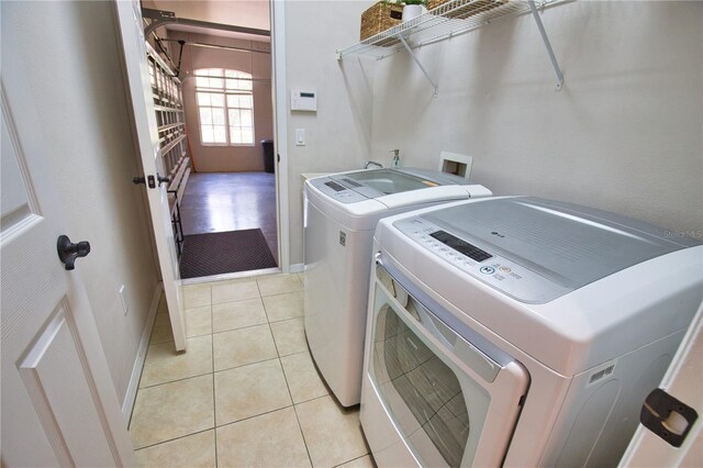 8209 Snowy Egret Pl, Bradenton, FL 34202 - laundry area featuring separate washer and dryer and light tile patterned floors