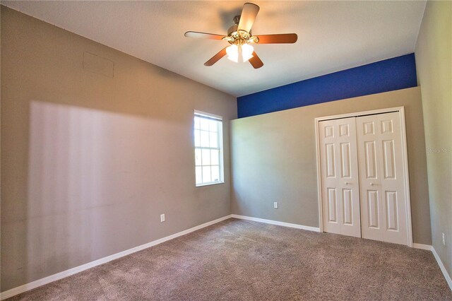 8209 Snowy Egret Pl, Bradenton, FL 34202 - unfurnished bedroom featuring carpet flooring, baseboards, a closet, and ceiling fan