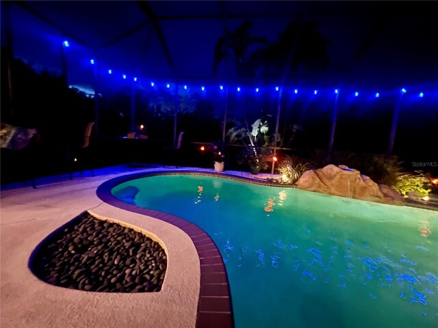 8209 Snowy Egret Pl, Bradenton, FL 34202 - pool at night with an outdoor pool