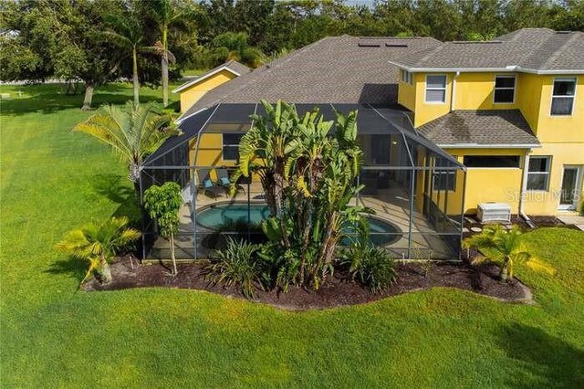 8209 Snowy Egret Pl, Bradenton, FL 34202 - rear view of property featuring a lanai, stucco siding, an outdoor pool, and a patio area
