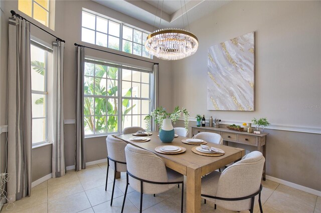 8209 Snowy Egret Pl, Bradenton, FL 34202 - dining room with baseboards, a chandelier, light tile patterned floors, and a high ceiling