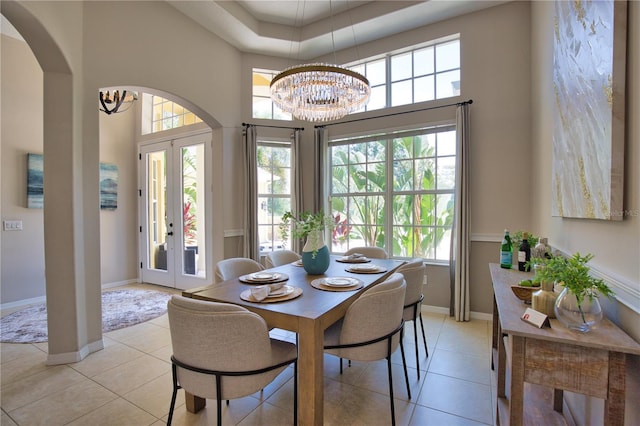 8209 Snowy Egret Pl, Bradenton, FL 34202 - dining room with a chandelier, french doors, a towering ceiling, plenty of natural light, and light tile patterned floors