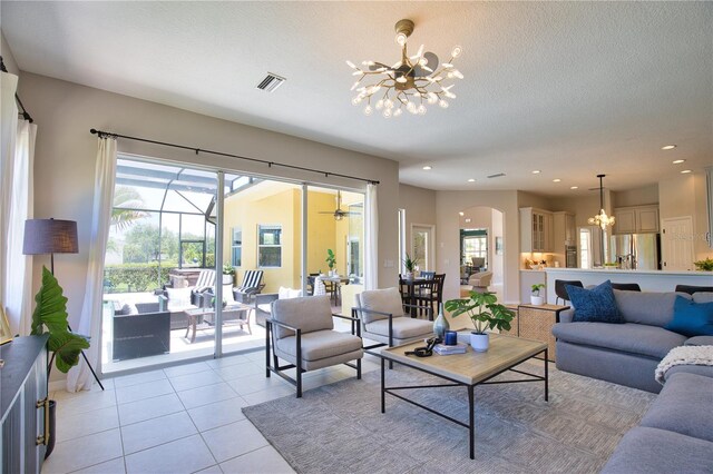 8209 Snowy Egret Pl, Bradenton, FL 34202 - living room featuring a chandelier, healthy amount of natural light, arched walkways, light tile patterned floors, and recessed lighting