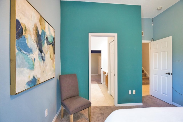 8209 Snowy Egret Pl, Bradenton, FL 34202 - carpeted bedroom featuring baseboards, tile patterned flooring, and ensuite bath