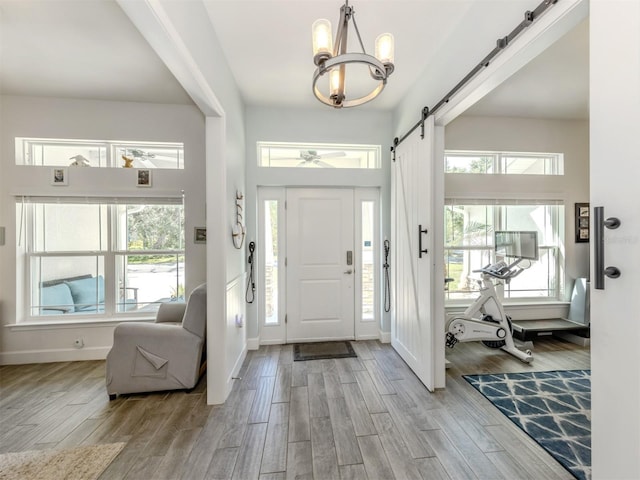 460 Bard Rd, Venice, FL 34293 - entryway with a chandelier, wood finished floors, healthy amount of natural light, and baseboards