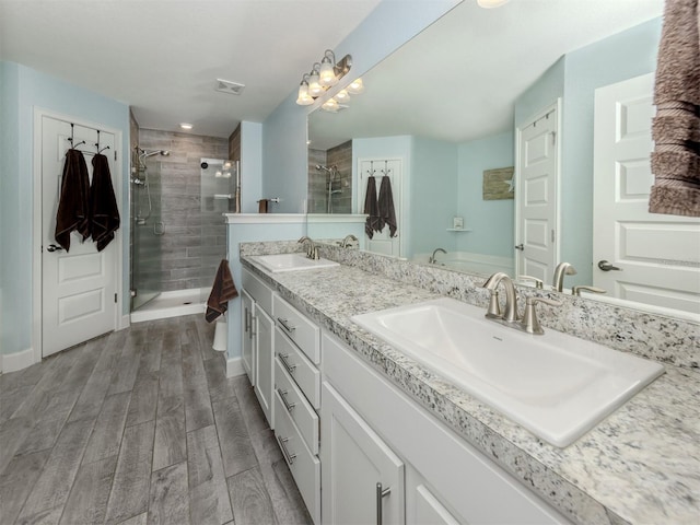 460 Bard Rd, Venice, FL 34293 - full bath featuring a shower stall, double vanity, wood finished floors, and baseboards